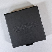 A black By Wue gift box with Good Things debossed on the lid.