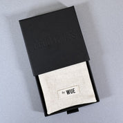 A cotton by Wue pouch inside the black Good Things gift box.
