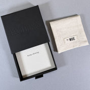 The Good Things gift box open with the printed card inside, and the cotton by Wue pouch alongside.