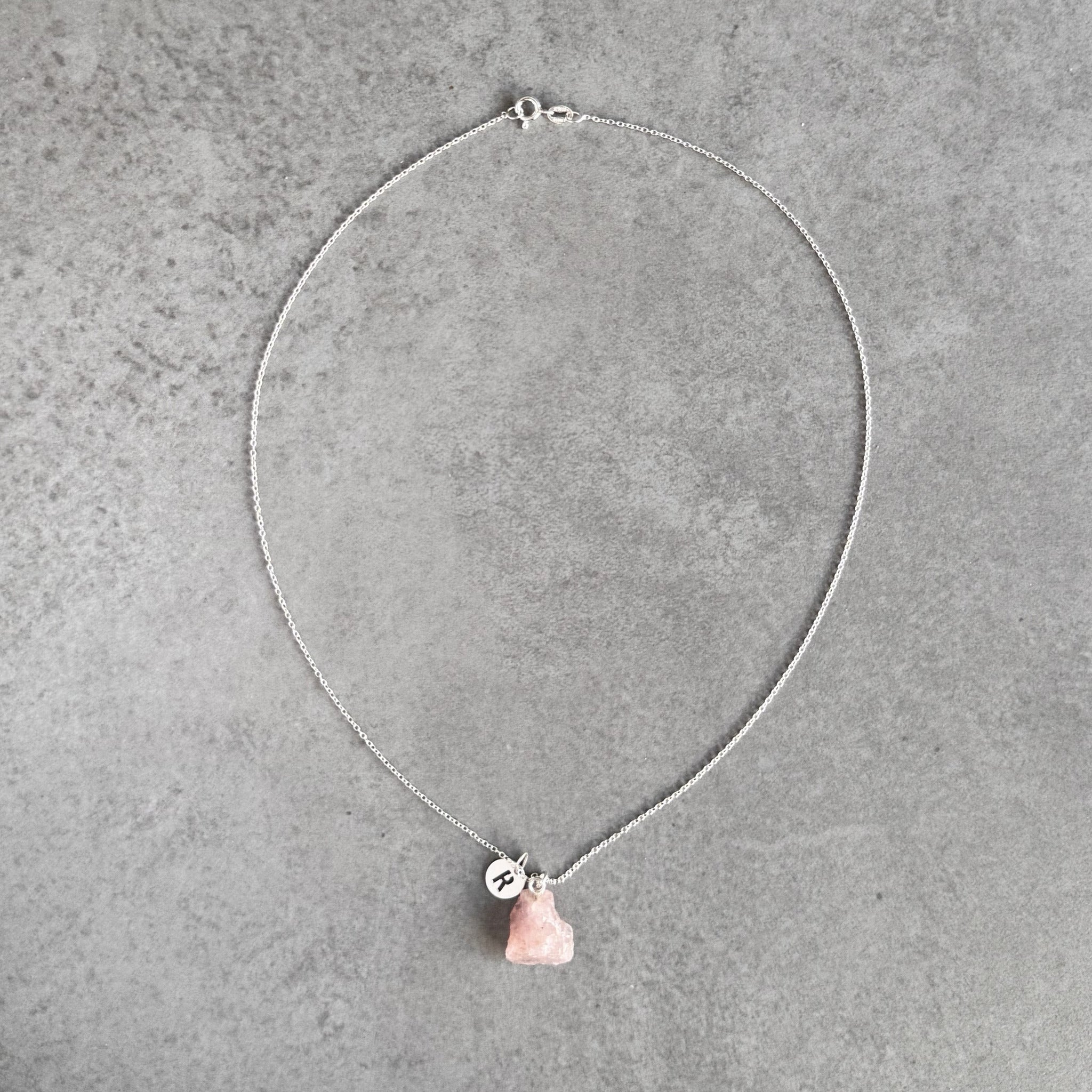 Initial necklace with rose quartz in sterling silver by By Wue